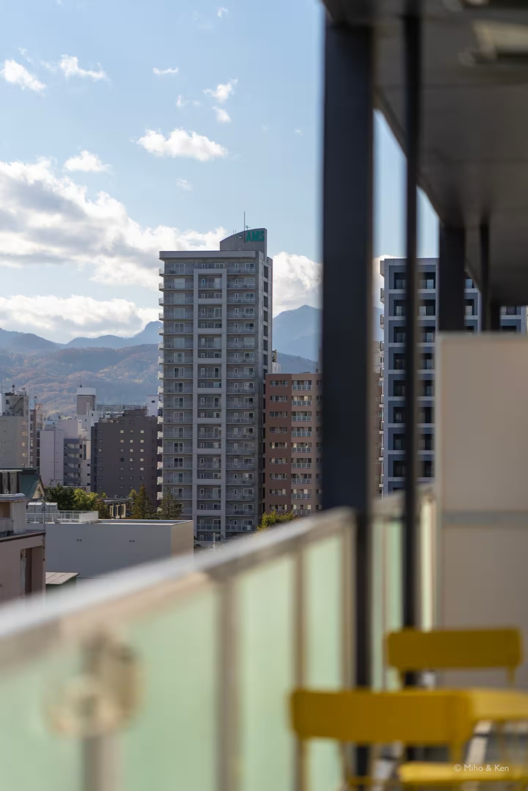 バルコニー越しに見える札幌の街と山並み